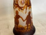 a brown vase with a picture of a man and a woman on it