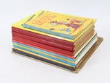 books stacked on top of each other on a white surface