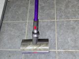 a vacuum that is sitting on the floor in the bathroom