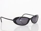sunglasses on a white surface with a reflection of the lens