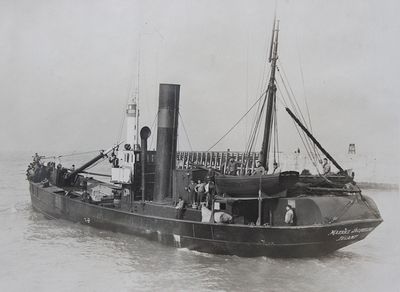 black and white photo of a boat with people on it in a body of water