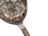 a silver spoon with a decorative design on it