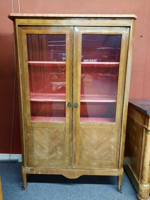 un meuble en bois avec des portes en verre dans une pièce