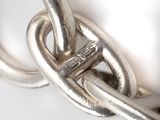 a close up of a chain with a ring on it