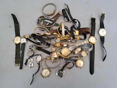 a lot of watches that are laying on the table