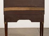 an old wooden desk with a brass plate on top of it