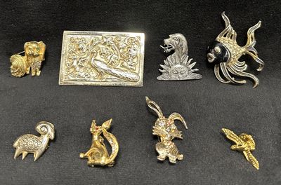 a lot of silver and gold items on a black surface