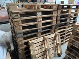 several wooden pallets stacked on top of each other in a warehouse