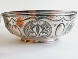a silver bowl that is sitting on a table