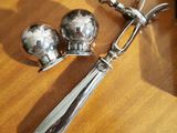 a silver spoon and two silver spoons on a wooden table