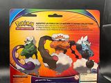 a box of pokemon figures on display on a black surface