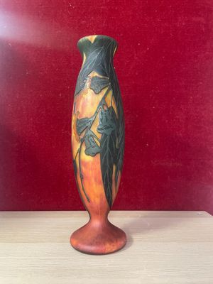 a vase that is sitting on a table in front of a red wall