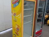two vending machines are lined up outside of a building