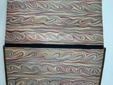 a close up of a wooden box on a white surface