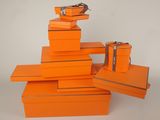 several orange boxes stacked on top of each other on a white surface