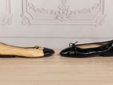 two pairs of black and beige shoes sitting on a wooden floor