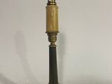 an antique brass table lamp on a white background with a black cord