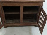 a wooden cabinet with a door open on the floor