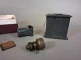 a small metal box and a small metal object on a table