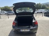 cars parked in a parking lot with open trunk of a car