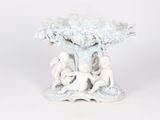 porcelain figurine of two children playing under a tree