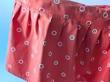 a red baby stroller with a polka dot pattern on it