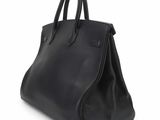black leather handbag on white background with clipping for text