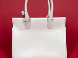 a white handbag on a red background