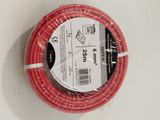 a roll of red wire wrapped in plastic on a white surface