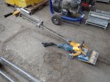 a machine that is sitting on the ground next to some pallets