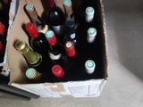 many bottles of wine in a box on the floor
