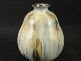 a small vase that is sitting on a black surface