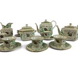 several pieces of porcelain tea and coffee set on a white surface