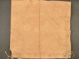an old piece of tan cloth with small holes on it