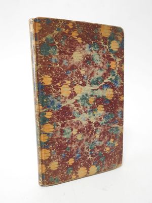 an old book with red and blue paint on it