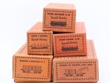 four boxes of various types of wooden stamps are stacked on top of each other