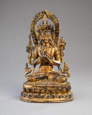 an image of a gold statue of a man holding a snake
