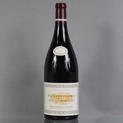 a bottle of red wine sitting on top of a glass table