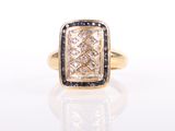 a close up of a gold ring with a diamond and blue sapphire