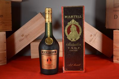 a bottle of wine sitting next to a box of wine
