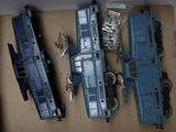 three toy trains sitting in a box on a table