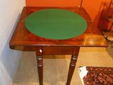 a small wooden table with a green mat on top of it