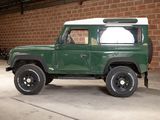 an image of a green land rover parked in a garage