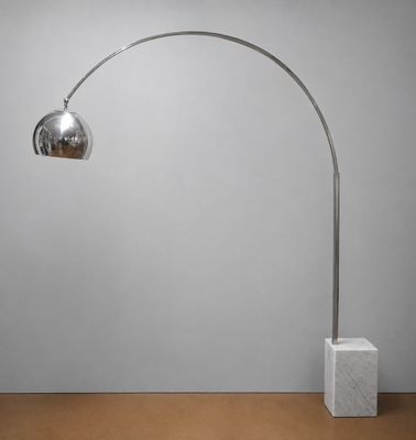 a chromed metal floor lamp with a marble base and a marble base