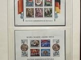 two framed stamps with german and german flags are on display