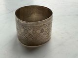 a silver cup that is sitting on a table