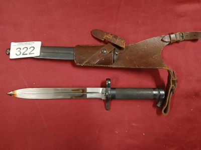 two old knives with leather sheaths on a red background