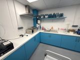 an image of a lab with blue cabinets and white counter tops