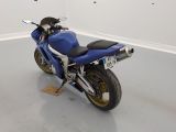 a blue motorcycle that is parked in a room