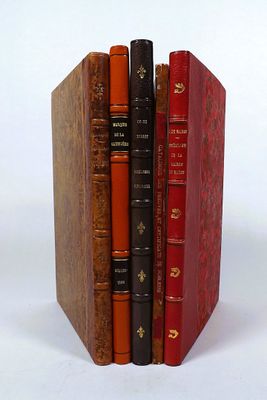 three books stacked on top of each other on a white surface